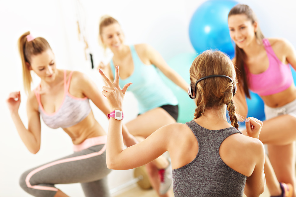 Group of smiling people doing aerobics